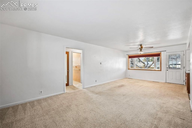 unfurnished living room with ceiling fan and light colored carpet