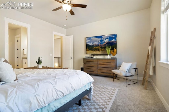 carpeted bedroom featuring ceiling fan and ensuite bath