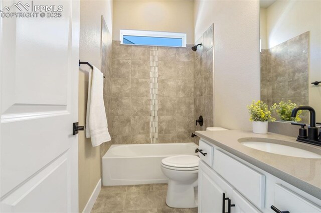 full bathroom featuring tile patterned floors, toilet, vanity, and tiled shower / bath