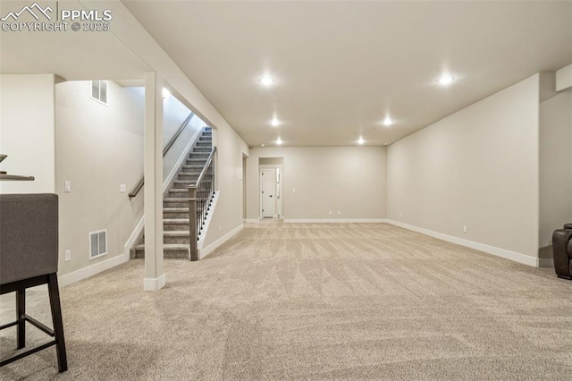 basement featuring light carpet