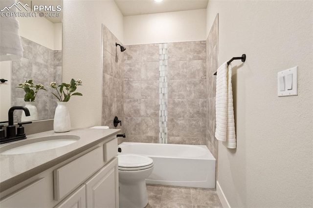 full bathroom with toilet, tile patterned floors, tiled shower / bath, and vanity