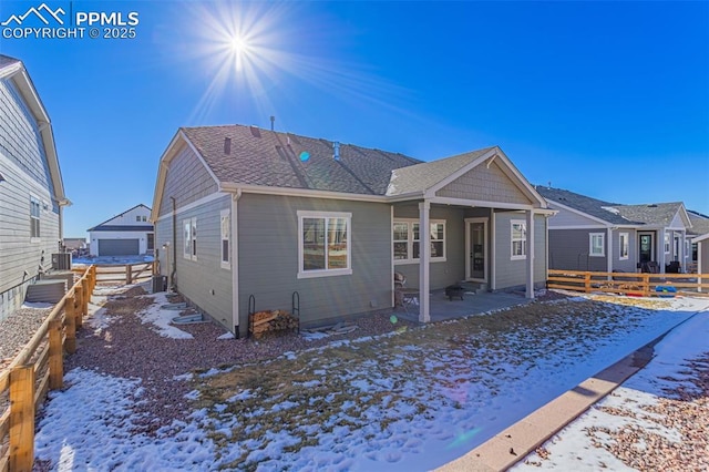 view of front of home with central AC unit and a garage