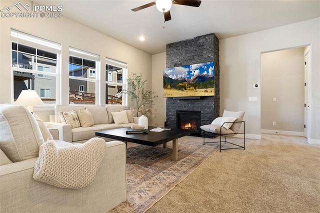 living room with ceiling fan and a fireplace