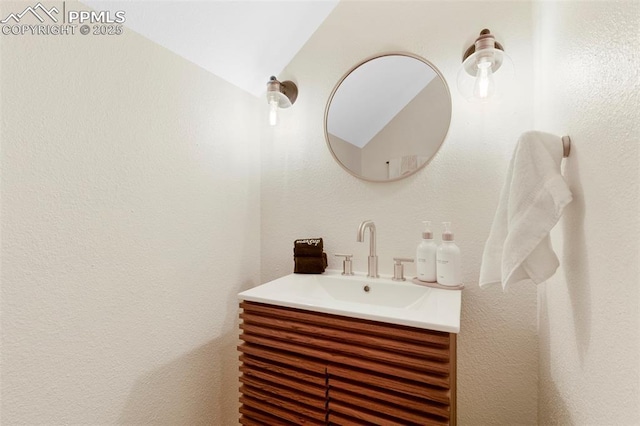 bathroom featuring vanity and vaulted ceiling