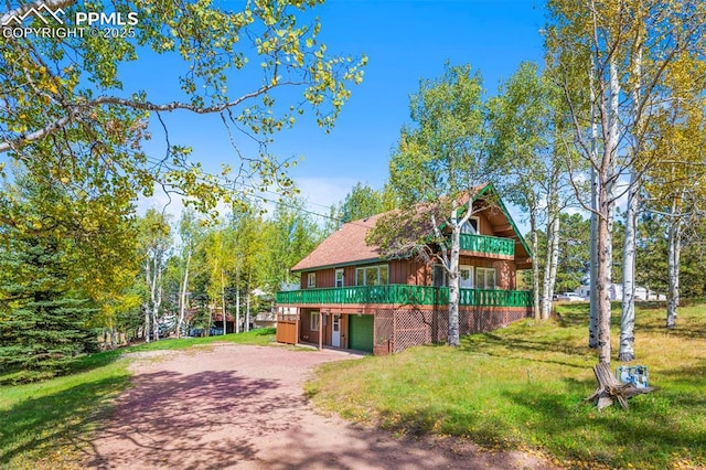 exterior space with a garage and a front lawn