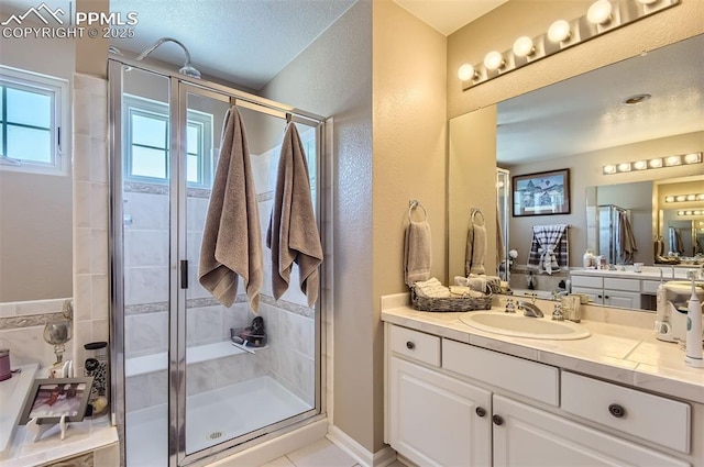 bathroom with vanity, tile patterned floors, and a shower with shower door