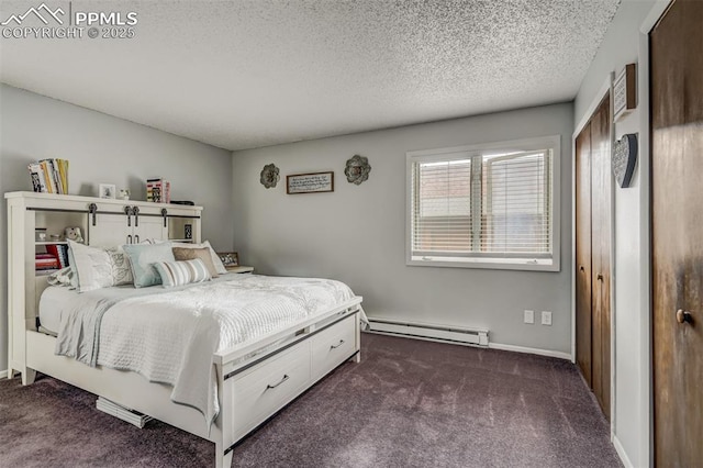 bedroom with dark colored carpet, a textured ceiling, and a baseboard heating unit