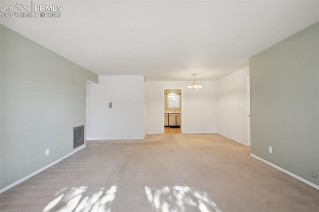 unfurnished living room with light colored carpet and a notable chandelier