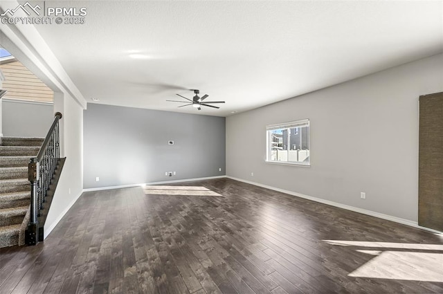 unfurnished living room featuring ceiling fan and dark hardwood / wood-style floors