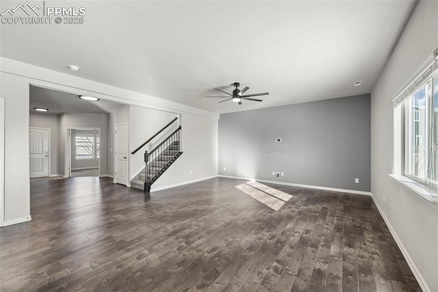 unfurnished living room featuring dark hardwood / wood-style floors, ceiling fan, and a healthy amount of sunlight