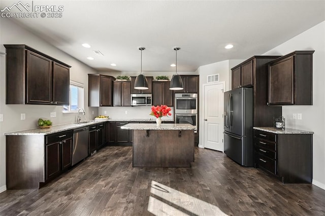 kitchen with a center island, hanging light fixtures, dark hardwood / wood-style floors, dark brown cabinets, and stainless steel appliances