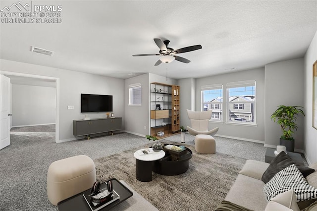 carpeted living room featuring ceiling fan