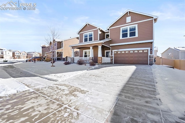 view of front of home featuring a porch and a garage