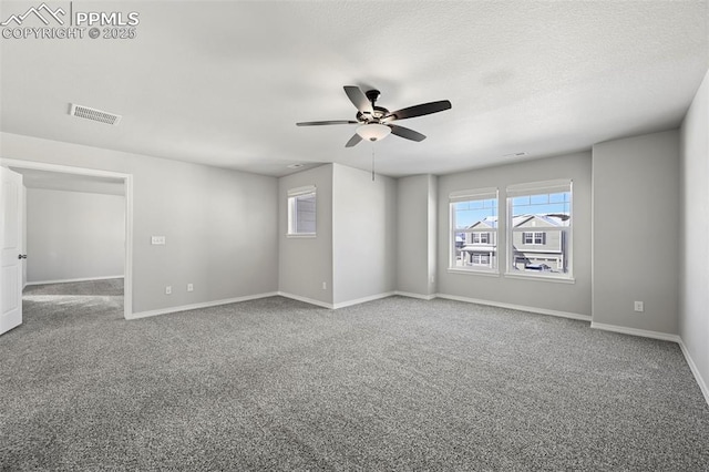 unfurnished room with carpet flooring and ceiling fan