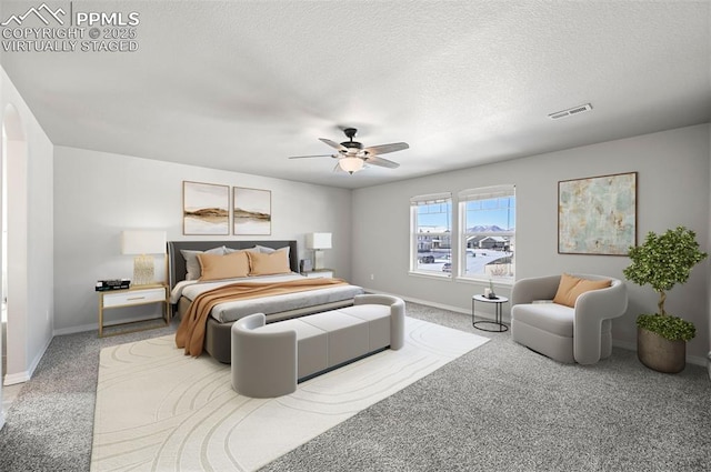 bedroom featuring carpet, a textured ceiling, and ceiling fan