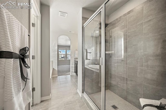 bathroom with vanity, tile patterned floors, and walk in shower