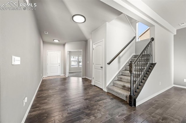 stairs featuring a wealth of natural light and hardwood / wood-style floors