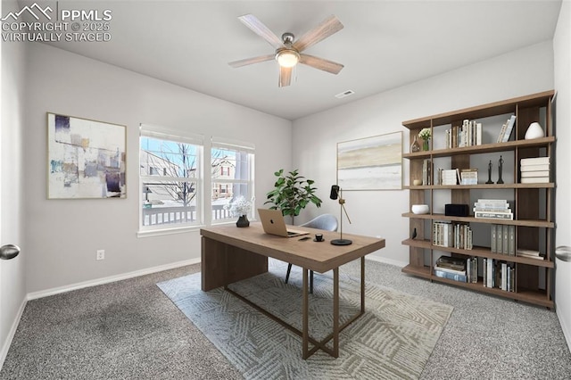 carpeted office space featuring ceiling fan