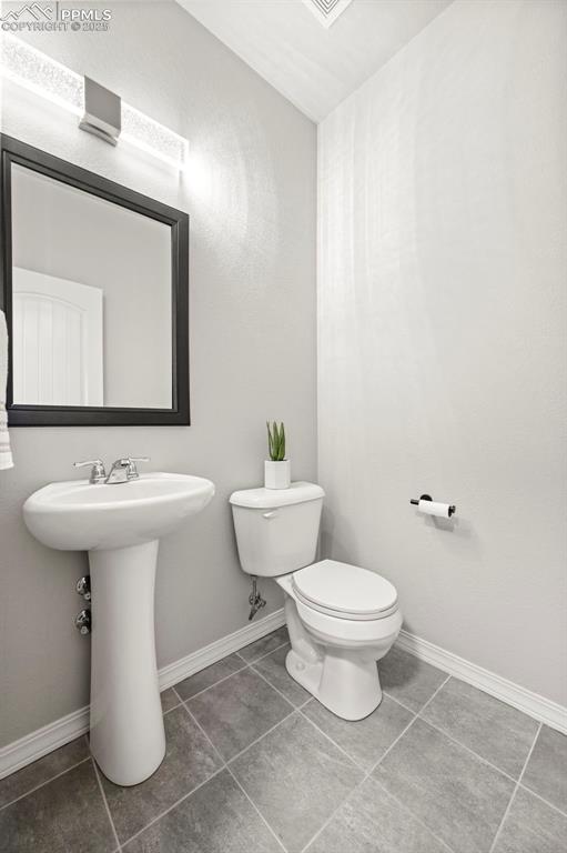 bathroom with tile patterned floors and toilet