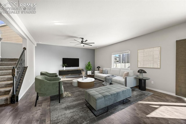 living room featuring ceiling fan and dark wood-type flooring