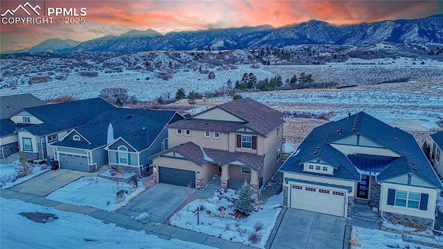 snowy aerial view with a mountain view