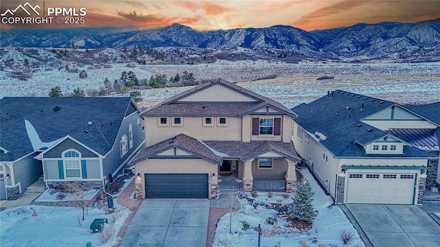 view of front of property with a mountain view and a garage