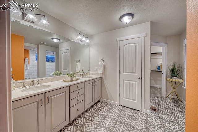 bathroom with vanity and a textured ceiling