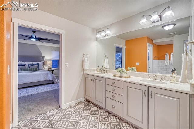 bathroom featuring vanity, a textured ceiling, and ceiling fan