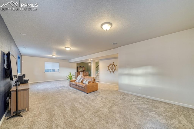 carpeted living room featuring a textured ceiling