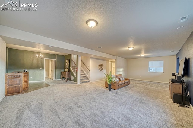 carpeted living room with a textured ceiling and an inviting chandelier