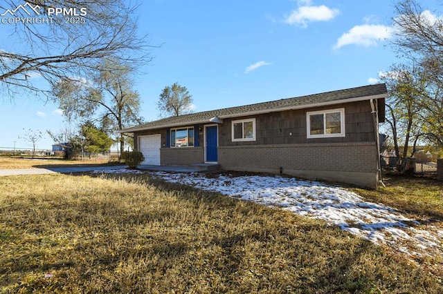 ranch-style home with a front yard and a garage