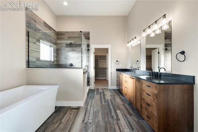 bathroom featuring independent shower and bath and vanity