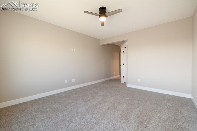 carpeted spare room featuring ceiling fan