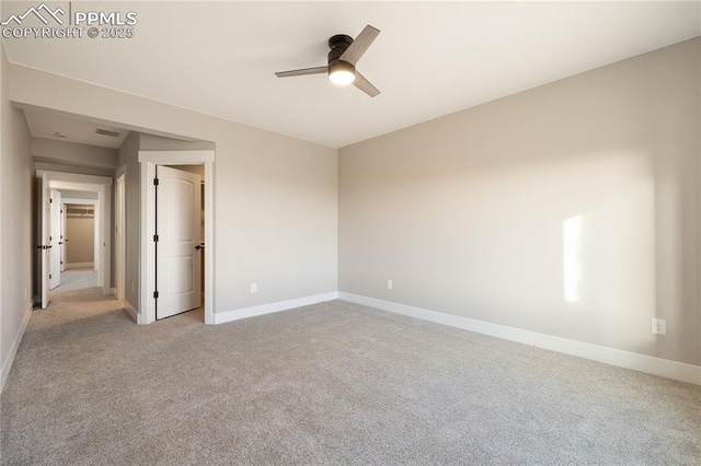 empty room with ceiling fan and light carpet