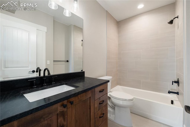 full bathroom featuring toilet, tiled shower / bath combo, and vanity