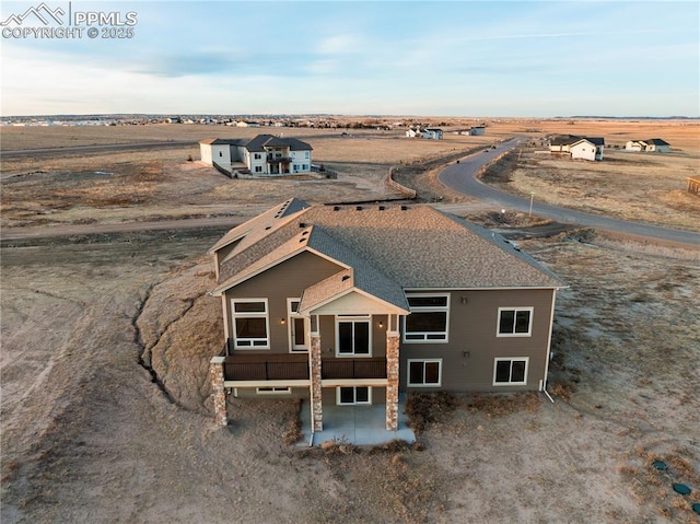 birds eye view of property with a rural view