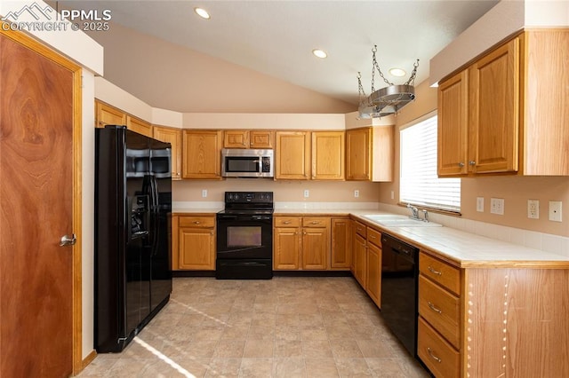 kitchen featuring sink, lofted ceiling, and black appliances