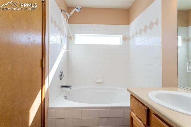 bathroom with vanity and tiled shower / bath combo