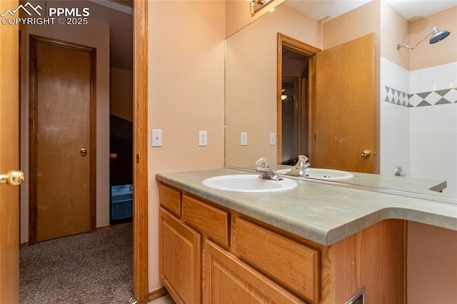 bathroom featuring walk in shower and vanity