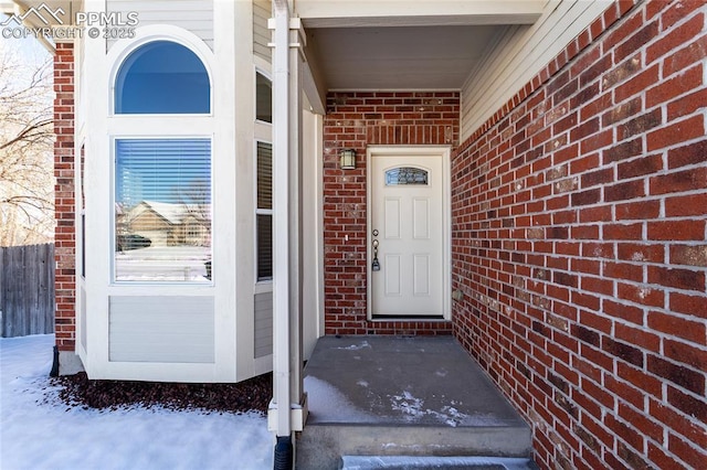 view of snow covered property entrance