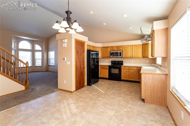 kitchen featuring black appliances, decorative light fixtures, an inviting chandelier, and lofted ceiling