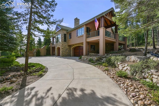 view of front of home featuring a balcony and a garage