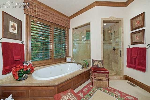 bathroom featuring ornamental molding and independent shower and bath