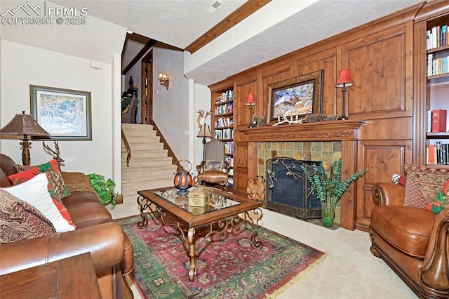 carpeted living room with a fireplace and a textured ceiling