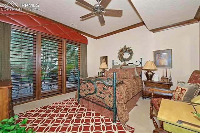 carpeted bedroom featuring ceiling fan, crown molding, and a textured ceiling