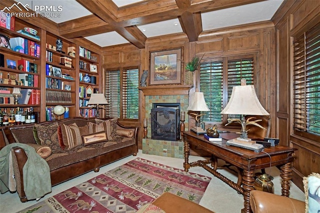 home office featuring beam ceiling, coffered ceiling, built in features, wooden walls, and a fireplace