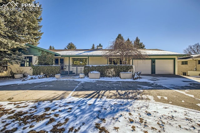 ranch-style home featuring a garage