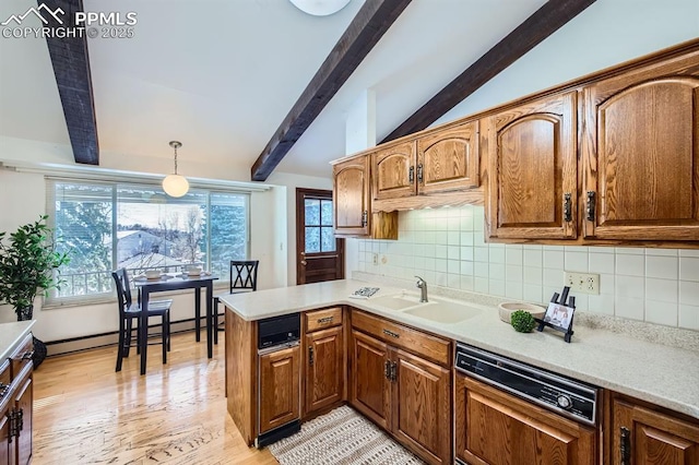 kitchen with a baseboard heating unit, lofted ceiling with beams, sink, hanging light fixtures, and kitchen peninsula