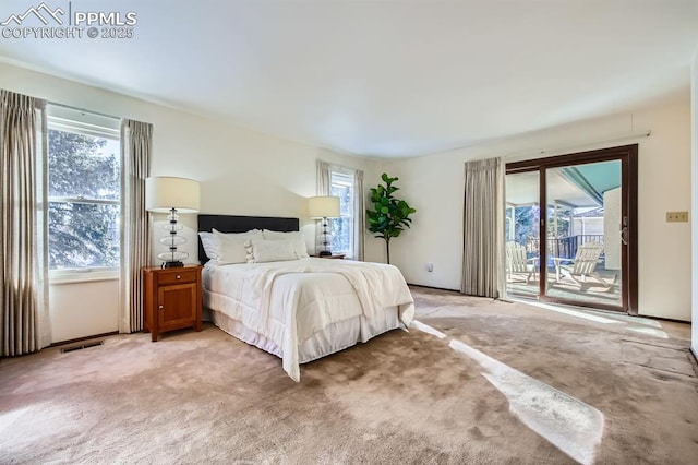 carpeted bedroom featuring access to outside