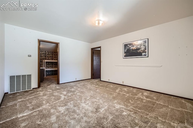 unfurnished bedroom with carpet, a spacious closet, and a closet